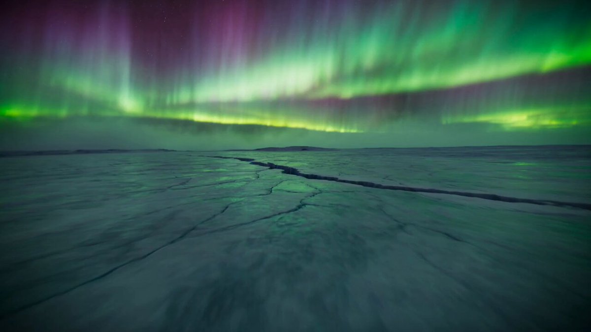 First-person FPV drone shot diving into a frozen arctic…