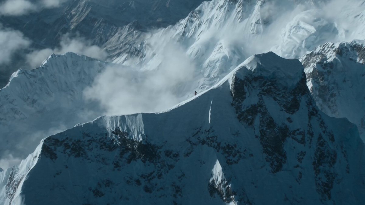 Create a 15-second ultra-photorealistic cinematic survival and mountaineering sequence…
