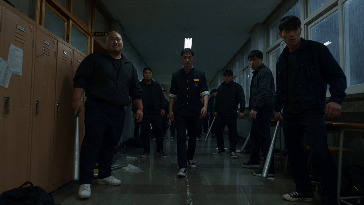 deserted Korean high school hallway at night, illuminated by…