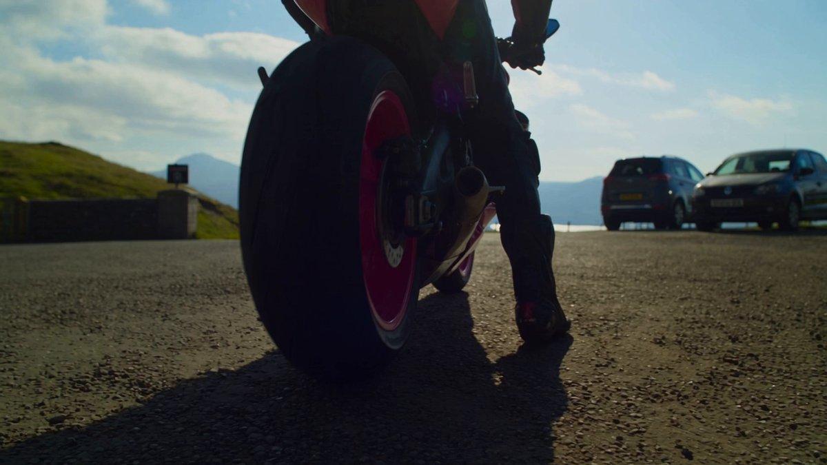 Create an explosive, high-speed motorcycle action sequence in 16:9,…